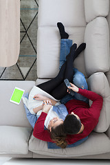 Image showing Young couple on the sofa watching television top view