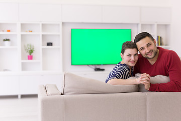 Image showing couple hugging and relaxing on sofa