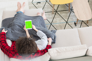 Image showing couple relaxing at  home with tablet computers