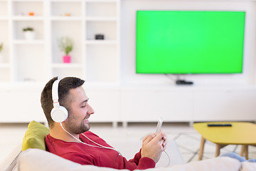 Image showing man enjoying music through headphones