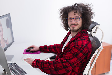 Image showing graphic designer in bathrobe working at home