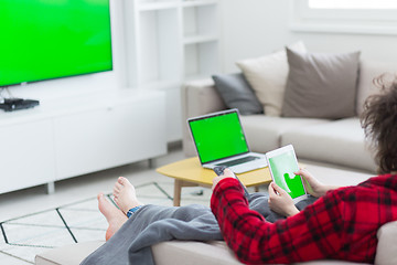 Image showing couple relaxing at  home with tablet computers