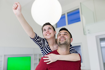 Image showing handsome man piggybacking his girlfriend