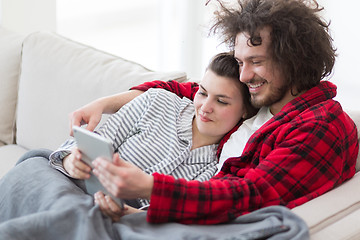 Image showing couple relaxing at  home with tablet computers