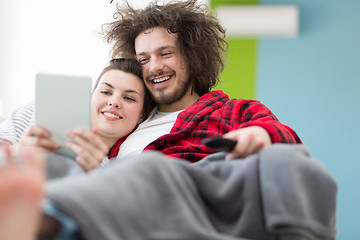 Image showing couple relaxing at  home with tablet computers