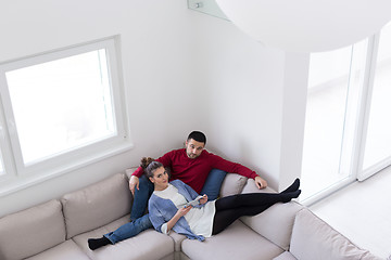 Image showing couple relaxing at  home with tablet computers