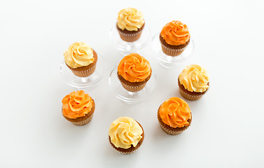 Image showing cupcakes with frosting on confectionery stands