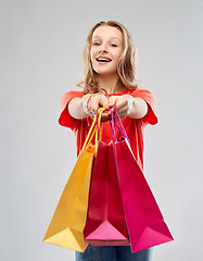 Image showing smiling teenage girl with shopping bags