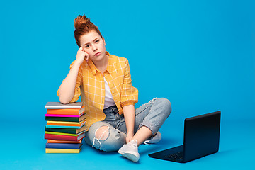 Image showing sad red haired teenage student girl with laptop