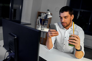 Image showing businessman with drink using smartphone at office