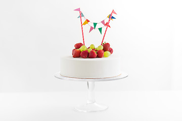 Image showing close up of birthday cake with garland on stand