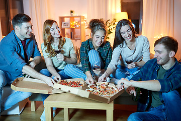 Image showing friends eating pizza and drinking red wine at home