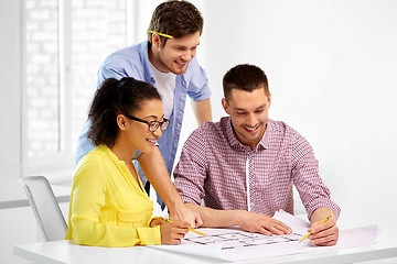 Image showing creative team with blueprint working at office