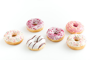 Image showing close up of glazed donuts on white table