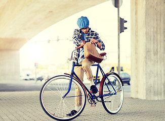 Image showing hipster man with shoulder bag on fixed gear bike