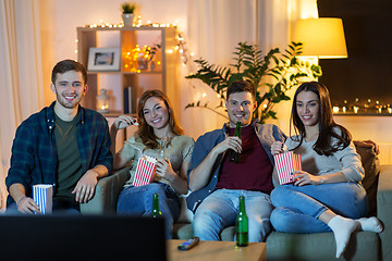 Image showing friends with beer and popcorn watching tv at home