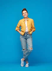 Image showing red haired teenage girl in shirt and torn jeans