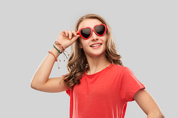 Image showing happy teenage girl in red heart shaped sunglasses