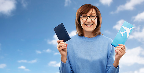 Image showing senior woman with passport and airplane ticket