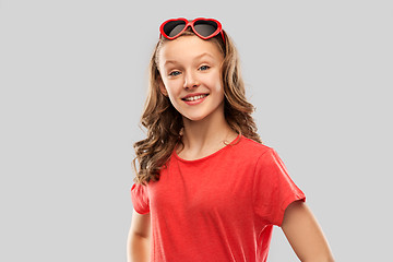 Image showing happy teenage girl in red heart shaped sunglasses