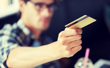 Image showing man paying with credit card at cafe