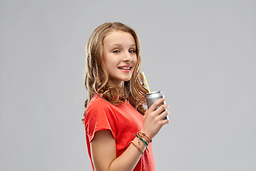 Image showing girl drinking soda from can through paper straw