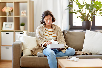 Image showing sick woman taking paper tissue from box at home