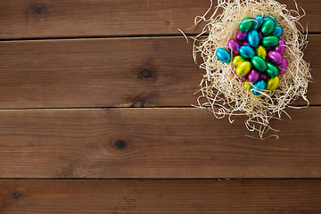 Image showing chocolate eggs in foil wrappers in straw nest