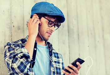 Image showing man with earphones and smartphone listening music