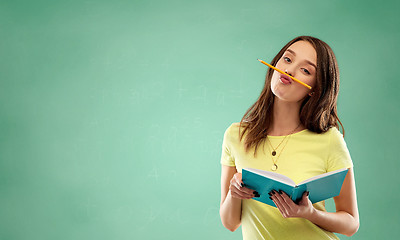 Image showing student girl with book and pencil over green