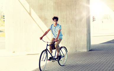 Image showing young hipster man riding fixed gear bike