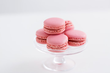 Image showing pink macarons on glass confectionery stand