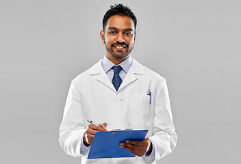 Image showing smiling indian doctor or scientist with clipboard