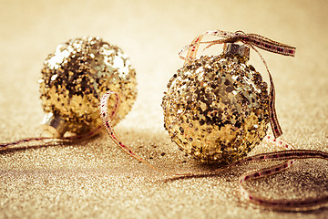 Image showing Golden christmas balls on glitter background with copy space