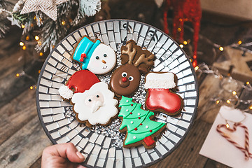 Image showing A plate of festive shaped gingerbread at Christmas time