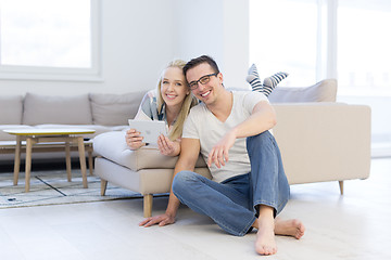 Image showing couple relaxing at  home with tablet computers