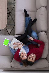 Image showing Young couple on the sofa watching television top view