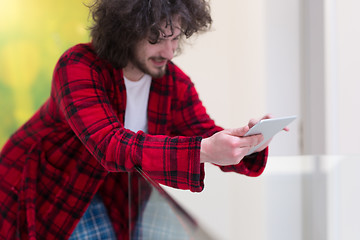 Image showing young freelancer using tablet computer