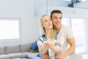 Image showing couple showing small red house in hands