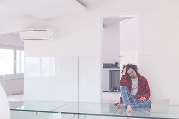 Image showing young freelancer in bathrobe working from home