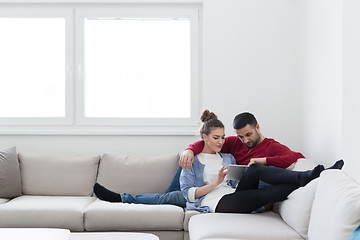 Image showing couple relaxing at  home with tablet computers