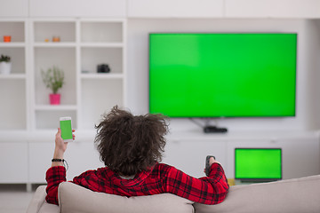 Image showing young man in bathrobe enjoying free time