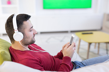 Image showing man enjoying music through headphones