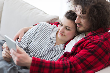 Image showing couple relaxing at  home with tablet computers