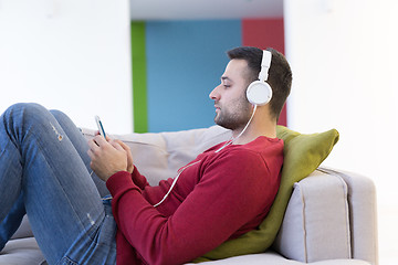 Image showing man enjoying music through headphones