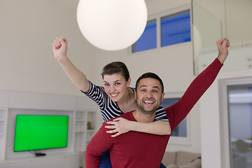 Image showing handsome man piggybacking his girlfriend