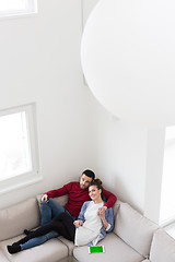 Image showing Young couple on the sofa watching television