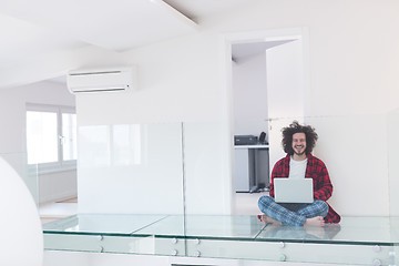 Image showing young freelancer in bathrobe working from home