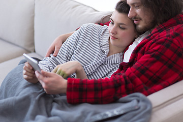 Image showing couple relaxing at  home with tablet computers