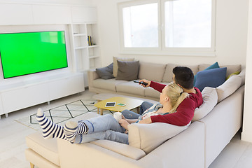 Image showing Young couple on the sofa watching television